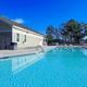 Outdoor swimming pool and poolside building photographed on the resort grounds — useful facility photo; appears on the property site as the pool image.