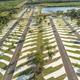 Angled aerial view focusing on the organized RV pads and access roads with the pond visible at the top — useful for showing site plan and scale.