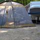 Tent and RV campsite setup showing ground surface, picnic table and immediate site layout — useful interior campsite view from the property’s amenities gallery.