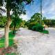 Wide view of RV sites and drive lanes with trees and utility hookups visible — useful for showing site layout; sourced from the Our Park page.