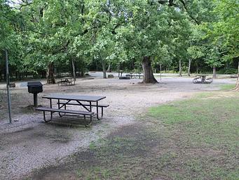 A picnic table and grill at the the Rock Creek Campground group site