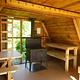 Twin Lakes Cabin scenery (AK) interior showing wood table, shelves and stove