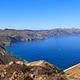 View from a high ridge overlooking the rest of a long, narrow, rugged island with steep cliffs.  