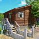 Close-up of a lakeside wooden cabin on stilts — highlights cabin accommodation style available at the resort.