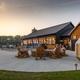 Outdoor patio/firepit seating area in front of the lodge/restaurant — shows communal facilities and dining/relaxation space on the property.