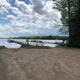 Lakeshore and dock scene on Pelican Lake with boat slips and shoreline — useful to show water access and marina facilities on the property.