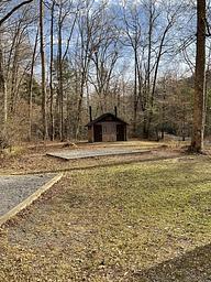 Pit toilet and tent pads on site. 
