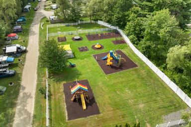 Aerial view focused on the fenced playground area within the campground — highlights family facilities and on‑site recreation spaces.