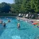 Active pool photo with people using the facility (aerobics/relaxation) — from the 'Our Resort' activities images, demonstrates pool amenities and usage.