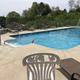 Clear photograph of the outdoor swimming pool and deck seating (from the homepage) — shows on-site pool facility available to guests.