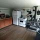 Kitchen with classic wood stove oven, modern oven and refrigerator