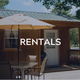 Clear photo of a rental cabin on the property (porch, outdoor table and umbrella) — directly relevant to the campground’s accommodations; image is used on the site’s Rentals section.