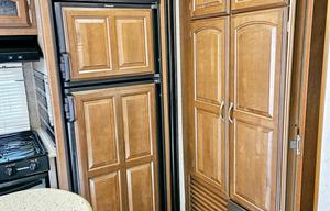 Large RV with outdoor kitchen, fireplace, and TVs