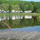 Foreground dock and pond with RVs visible across the water — good close scenic detail of the lake and recreation area (Gallery/Overview context).