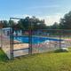 The campground swimming pool inside its fence, with loungers set out along the deck.
