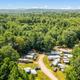Lower-altitude aerial showing RV pitches arranged around a loop road — documents site layout and density of RV accommodations visible on the property.