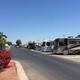 Long view of a paved internal road with multiple RV sites and hookups visible — good overview of typical RV pitches and site layout (from site gallery).