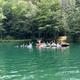 Activity at the pond with swimmers/floaters in the water — demonstrates recreation opportunities available on the property (from home page imagery).