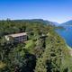 Aerial/overhead view showing the lodge building on wooded grounds directly above the Columbia River — good overall property overview. (Source page social/overhead image.)