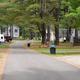 Panoramic view down a paved park road lined with RV sites and hookups — useful overview of typical RV pitches and site spacing. Source page: Park map header / park map context.