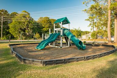 Playground area with slides and swings — depicts family-friendly on-site amenities; originates from the campground's image set on the website.