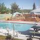On‑property swimming pool area with fencing, lounge seating and deck features—illustrates recreational facilities available at the campground (from the site gallery).