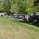 Shows a row of golf carts and RVs along a grassy area — useful overview of on‑site recreation and parking; sourced from the property's Activities page indicating these are onsite facilities.