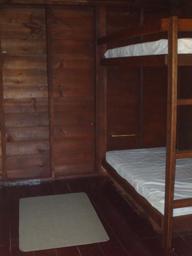Interior photo showing bunk beds inside a cabin — useful to illustrate cabin interior accommodations (from the rustic cabins page).
