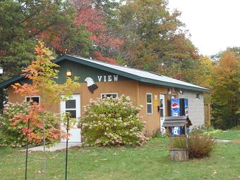 Building marked 'VIEW' (service/office or amenity building) set in campground with trees — documents on-site facilities and appearance (gallery image).
