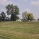 Entrance/grounds view with Haven Hills sign, open lawn and buildings in background — useful overall site/landscape overview.