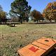 Handmade custom corn hole games provided to guests located near the playground in Brush Creek campground.