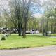Panoramic overview of RV area with multiple RVs, grassy loops and utility hookups — from the RV Camping / trailer-camp-sites page and provides a clear site-wide view of the campground’s RV section.