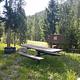 Threemile Campground Campsite 5 with picnic table, bear box, fire ring. Trees in background