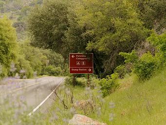 A large brown sign, pointing the way to the entrance of Potwisha Campground from the Generals Highway