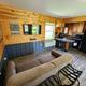 Cottage interior: living area and kitchenette in a wood-paneled cottage — demonstrates on-site cabin accommodation and amenities (from property rates/amenities gallery).