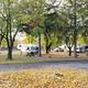 Wide shot of campground grounds showing multiple RVs, picnic tables, trees and paved lanes — good overall view of site layout (image hosted on the property homepage).