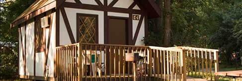Cabin exterior with deck and grill — good photo of on-site cabin accommodation (source: Rates/featured cabin image).