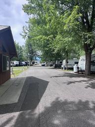 A row of rvs parked on the side of a road next to a building.