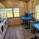 Picture of our new laundry facility, 4 stacked washer/dryers and laundry tables.