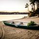 Beach/shoreline image with canoe on sand (Facilities page). Represents the resort's private beach and lakefront setting on Lake Wylie.