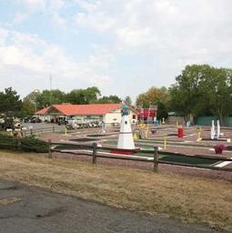 Wide view of the mini‑golf course and surrounding grounds with clubhouse in background — illustrates another on‑site recreation amenity (from the resort’s amenities page).