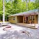 Clear exterior photo of a cottage on gravel pad with porch, picnic table and fire ring — good representation of on‑site cottages referenced on the property’s accommodation pages.