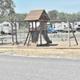 Playground with picnic table and RV sites visible behind it — shows family-friendly amenities and adjacent RV parking consistent with the property's gallery.