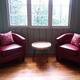 Two red chairs and a coffee table in living room.