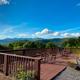 a deck with chairs and a view of the mountains