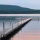 Long dock stretching into calm lake waters — highlights the campground’s waterfront access and dock facilities; image appears on the campground’s Map page.