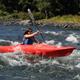 Single kayaker navigating rapids on the river — highlights on-site paddling activities and river conditions offered at the property.