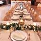 Interior banquet setup with long tables and place settings — shows the event/banquet facility available at the Raymond House venue (photo is on the venue homepage).