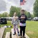 Open grassy area with parked RVs and flagpole—useful wide view of campground layout and common areas (from site gallery).