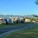 Row of RV sites with mountain panorama on a sunny summer day